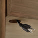 Cable management opening on Crate & Barrel Tate Walnut Bookcase Desk with Outlet keeps cords neatly organized