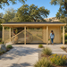 Carport Hugo 44 in the sunny Sierra foothills as two adults unload groceries from a vehicle behind the decorative wooden screens.
