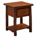 Cinnamon Fireside Lodge Log One Drawer Nightstand with Shelf is a rustic wooden nightstand with log legs, a flat top, one drawer, and an open shelf