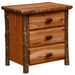 Cinnamon Fireside Lodge Log XL Three Drawer Nightstand is a rustic wood nightstand with three drawers, log-style corner posts, and a smooth flat top