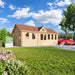 Clockhouse Bristol 44mm wooden garden room with a brown gabled roof, numerous tall windows and a decorative clock dormer, set on a landscaped lawn beside patio chairs and a red car.