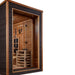 Close angle of Golden Designs Karlstad 6 Person Outdoor-Indoor PureTech Hybrid Full Spectrum Sauna showing the glass corner, cedar interior and the guarded stove inside