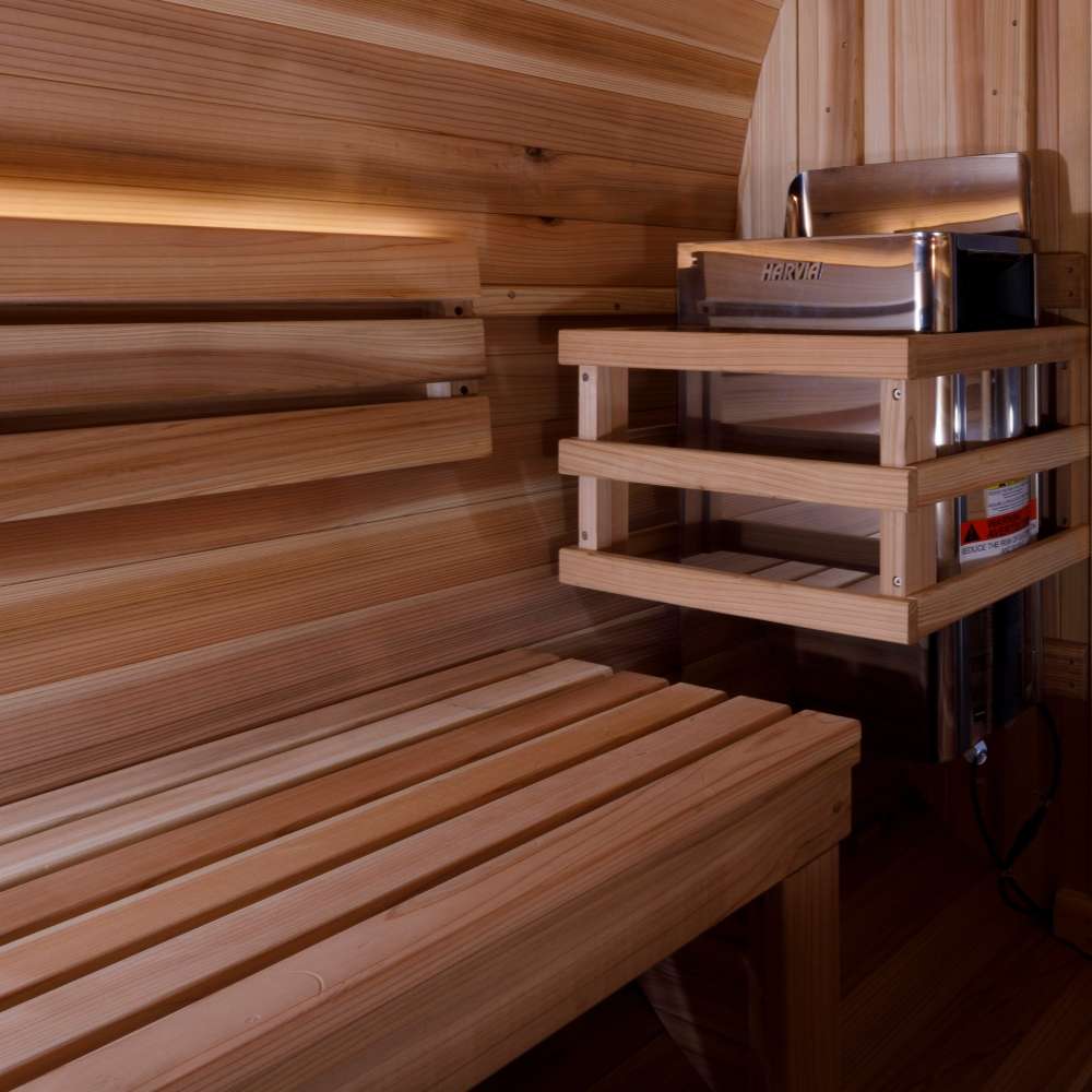 Close interior view of Golden Designs Zurich 4 Person Barrel with Bronze Privacy View Traditional Sauna showing slatted cedar benches and the guarded stove
