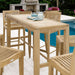 Close outdoor styling of Westminster Teak 5ft Laguna Teak Bar Table with simple decor near a poolside setting