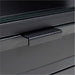 Close-up of Crate & Barrel Casement 60" Black Metal Desk featuring a textured black metal drawer handle and glass top edge