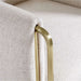 Close-up of Crate & Barrel Caterina Natural Upholstered Office Chair with Brass Base, highlighting the textured natural fabric and brushed brass arm frame