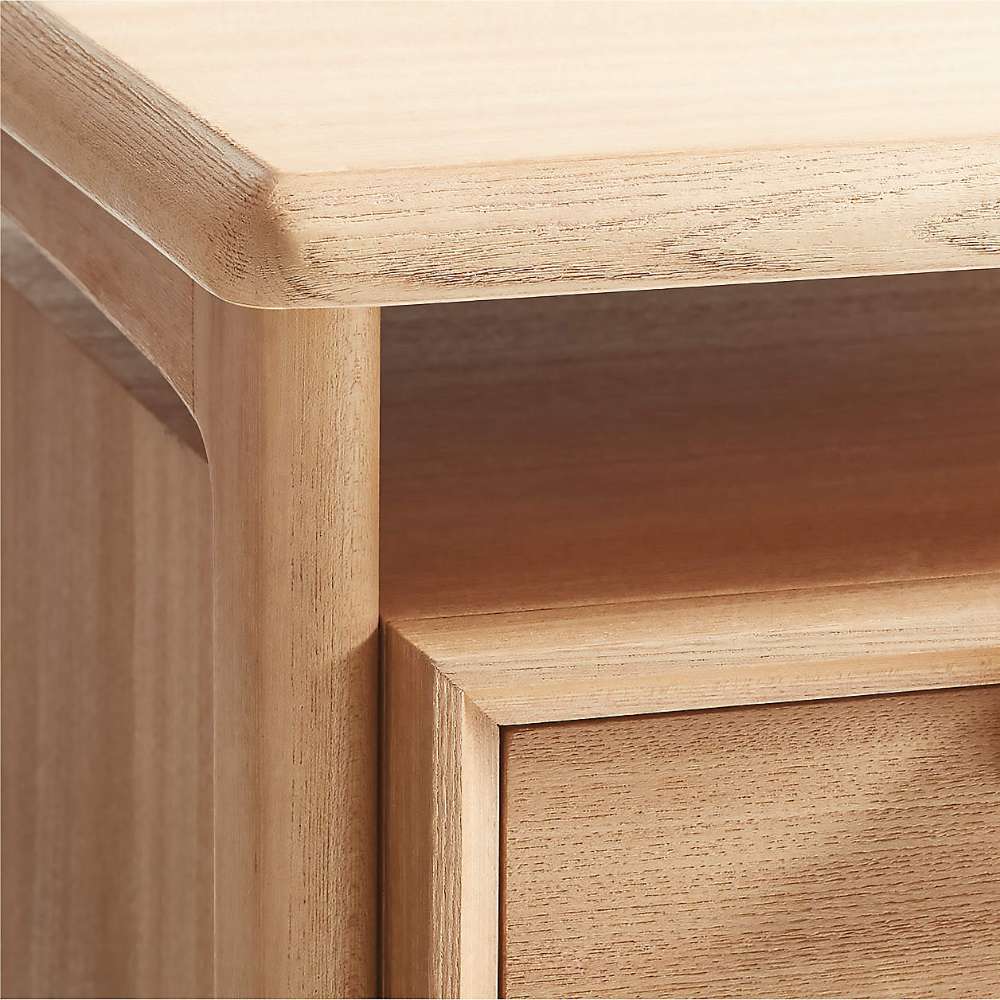 Close-up of Crate & Barrel Elias 66" Natural Elm Wood Desk with File Cabinet highlights its rounded corners, solid wood frame, and natural elm finish