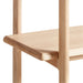 Close-up of Crate & Barrel Elias Natural Elm Wood Open Bookcase shelf highlighting its rounded edges and smooth natural wood grain