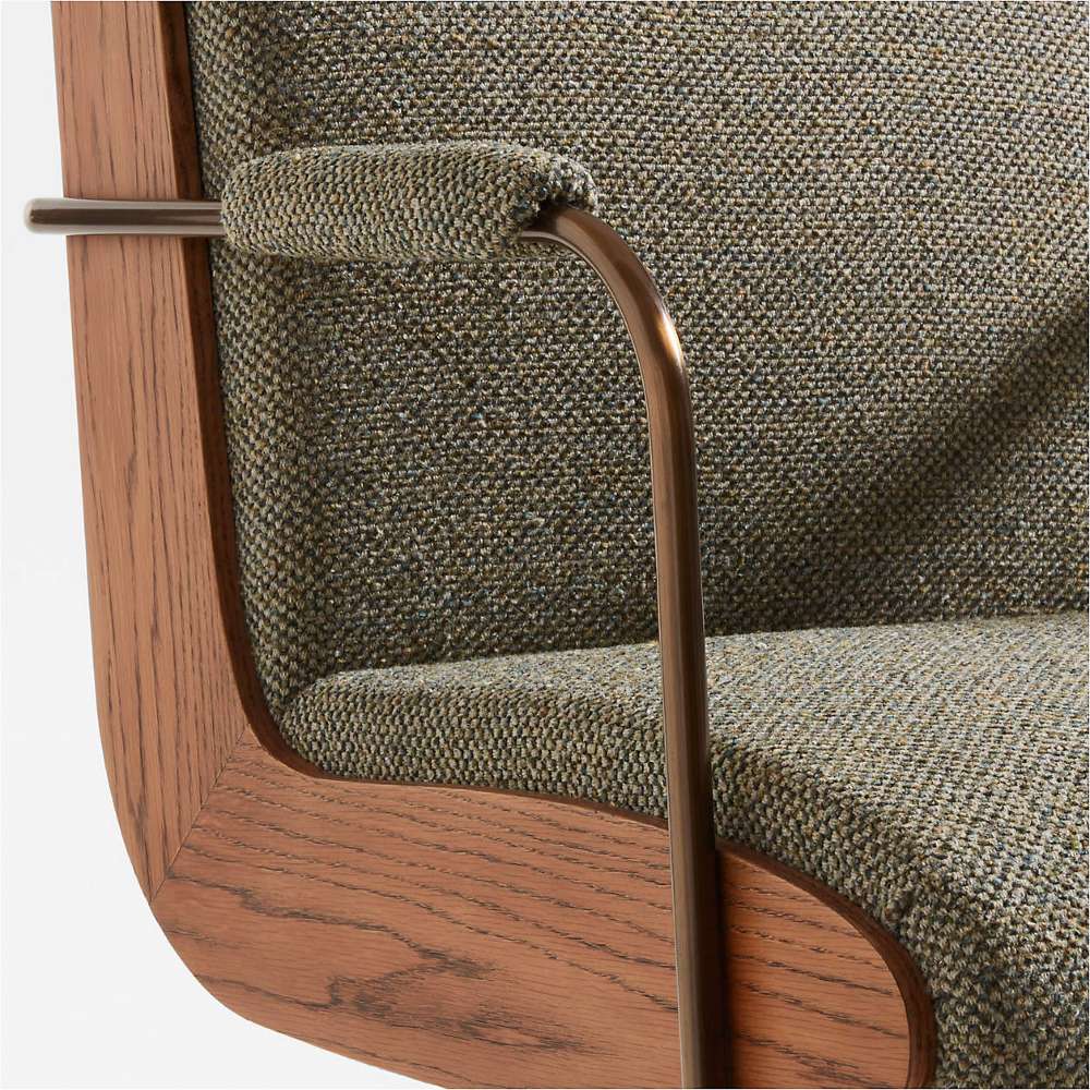 Close-up of Crate & Barrel Ellison Green Woven High-Back Office Chair highlighting woven fabric, wood detailing, and metal armrests