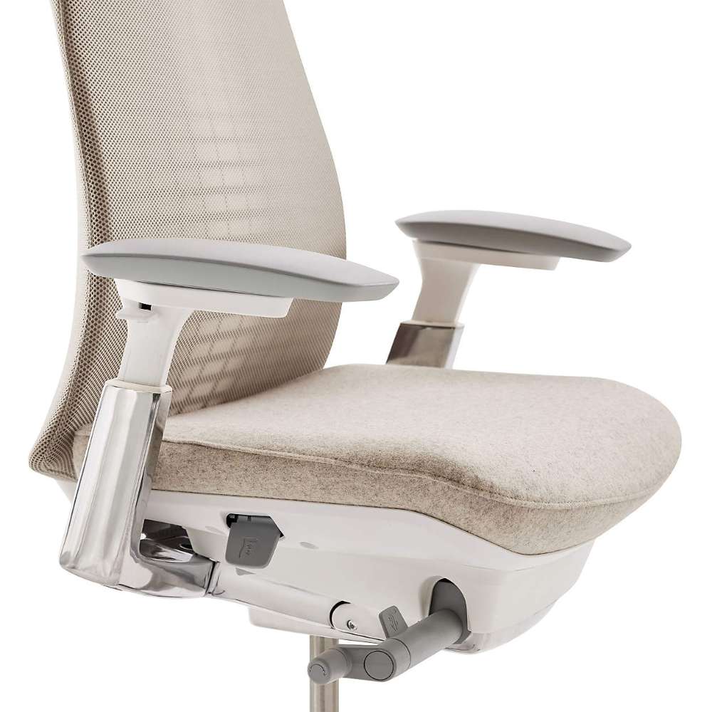 Close-up of Crate & Barrel Haworth Fern Upholstered Beach Office Chair seat, adjustable armrests, and under-seat adjustment controls
