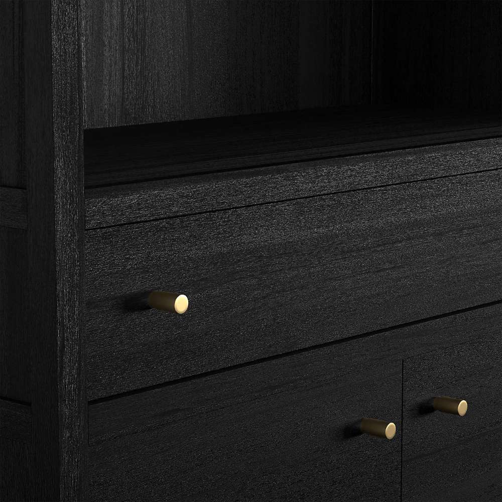 Close-up of Crate & Barrel Keane 40" Black Wood Storage Bookcase highlighting its black wood finish and brass hardware