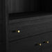 Close-up of Crate & Barrel Keane 40" Black Wood Storage Bookcase highlighting its black wood finish and brass hardware