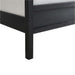 Close-up of Crate & Barrel Keane Black Solid Wood King Canopy Bed highlights the solid wood footboard corner with a smooth black finish