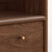 Close-up of Crate & Barrel Lafayette 36" Walnut Open Storage Bookcase highlighting its rounded wood edges and round brass drawer knob