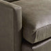 Close-up of Crate & Barrel Lounge Sofa showing the smooth gray leather upholstery, plush seat cushion, and clean track arm detail