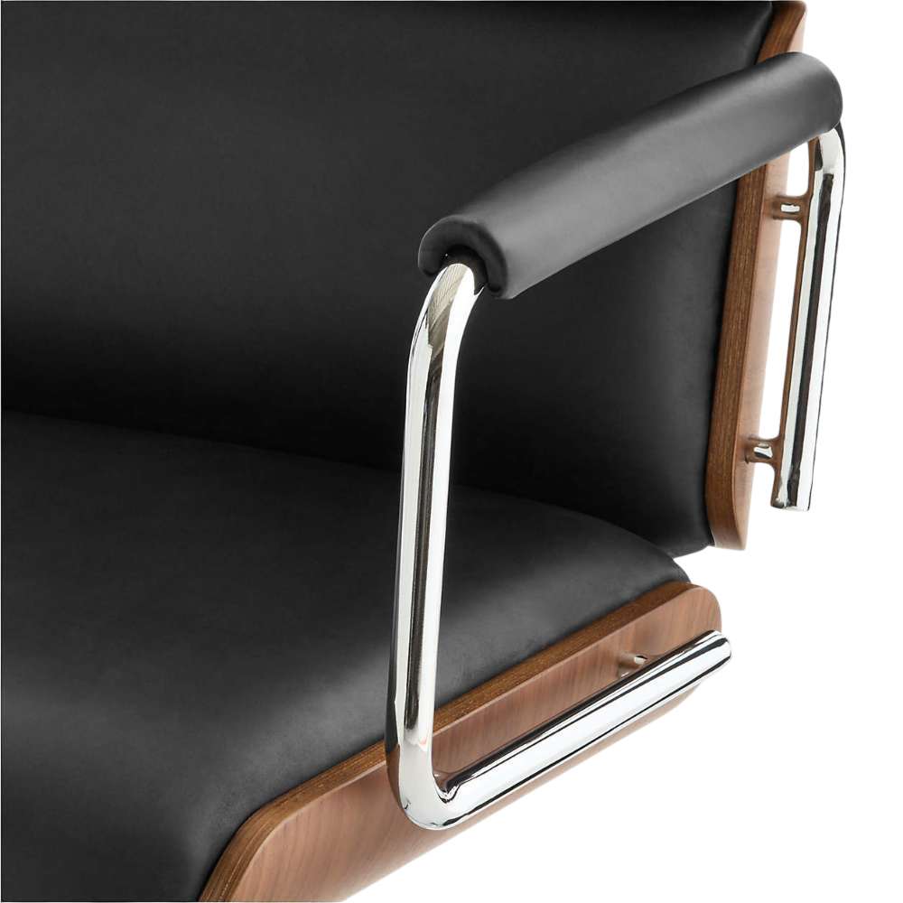 Close-up of Crate & Barrel Palmer Upholstered and Wood Paneled Office Chair highlighting black leather upholstery, chrome arms, and wood trim