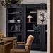 Close-up of Crate & Barrel Siena 34" Black Wood 4-Shelf Storage Bookcase with Drawer displaying books artwork and decorative accents