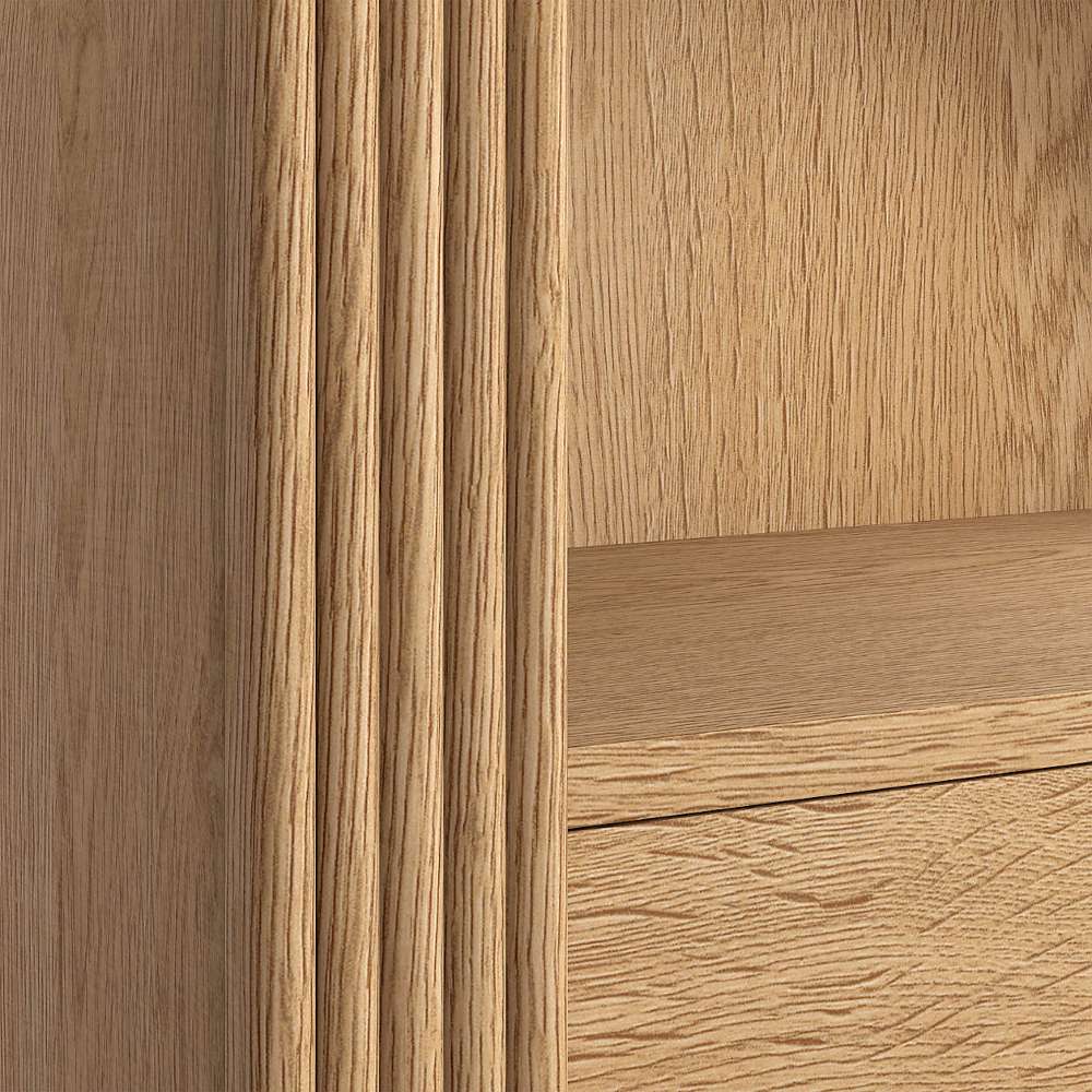 Close-up of Crate & Barrel Siena 34" Natural Wood 4-Shelf Storage Bookcase with Drawer highlighting natural wood grain and fluted accents