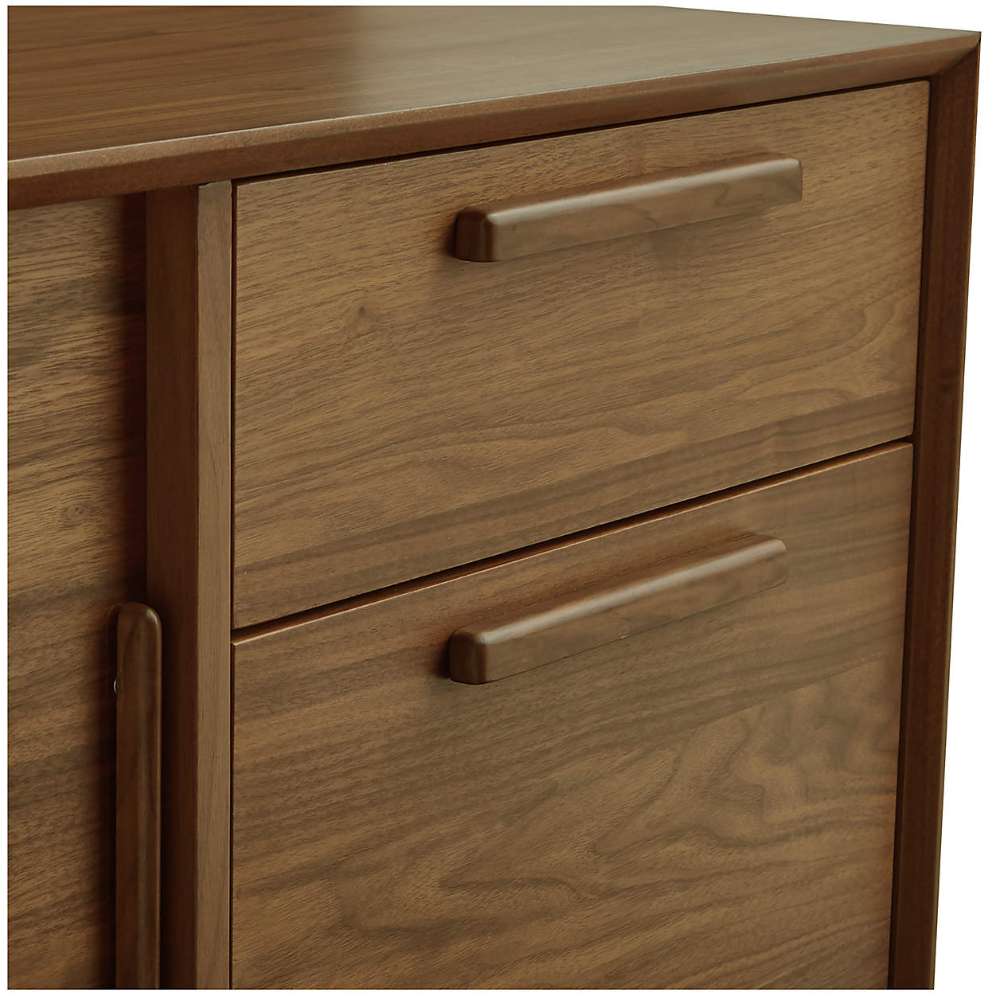 Close-up of Crate & Barrel Tate 80" Walnut Storage Media Console highlighting its walnut wood grain and integrated drawer pulls