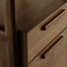 Close-up of Crate & Barrel Tate Walnut Bookcase File Cabinet highlighting the smooth walnut finish and sleek wooden drawer pulls
