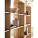 Close-up of Crate & Barrel Terrazza Natural Oak 5-Shelf Bookcases, Set of 2 highlights the open shelves displaying books, bowls, and decorative vases