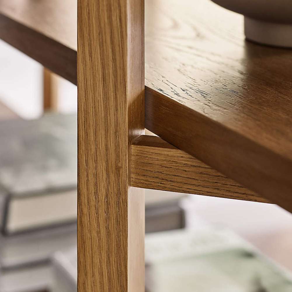Close-up of Crate & Barrel Thomas Barley Oak Wood Wide Open Bookcase/Room Divider showing the solid oak frame and shelf support detail.