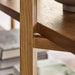 Close-up of Crate & Barrel Thomas Barley Oak Wood Wide Open Bookcase/Room Divider showing the solid oak frame and shelf support detail.
