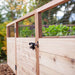 Close-up of Outdoor Living Today 8×5 Raised Garden Bed highlights its wooden frame, wire mesh panels, and black latch on the gate