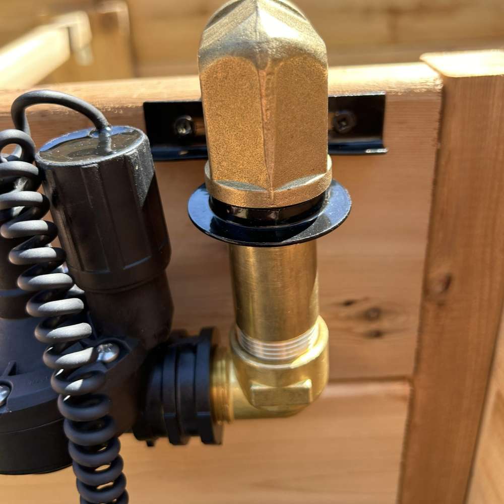 Close-up of Outdoor Living Today Raised Garden Bed Auto-Watering System brass valve and connector mounted on a wooden bed