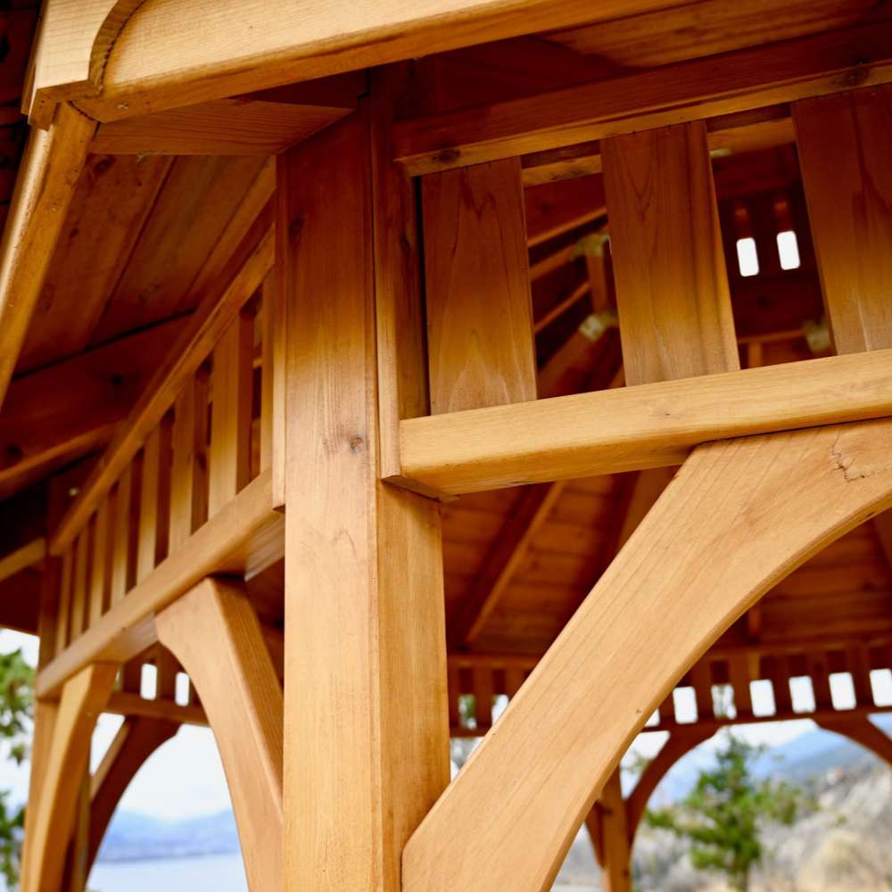 Close-up of Outdoor Living Today Western Red Cedar Octagon Bayside Gazebo highlighting its smooth cedar posts and curved support beams