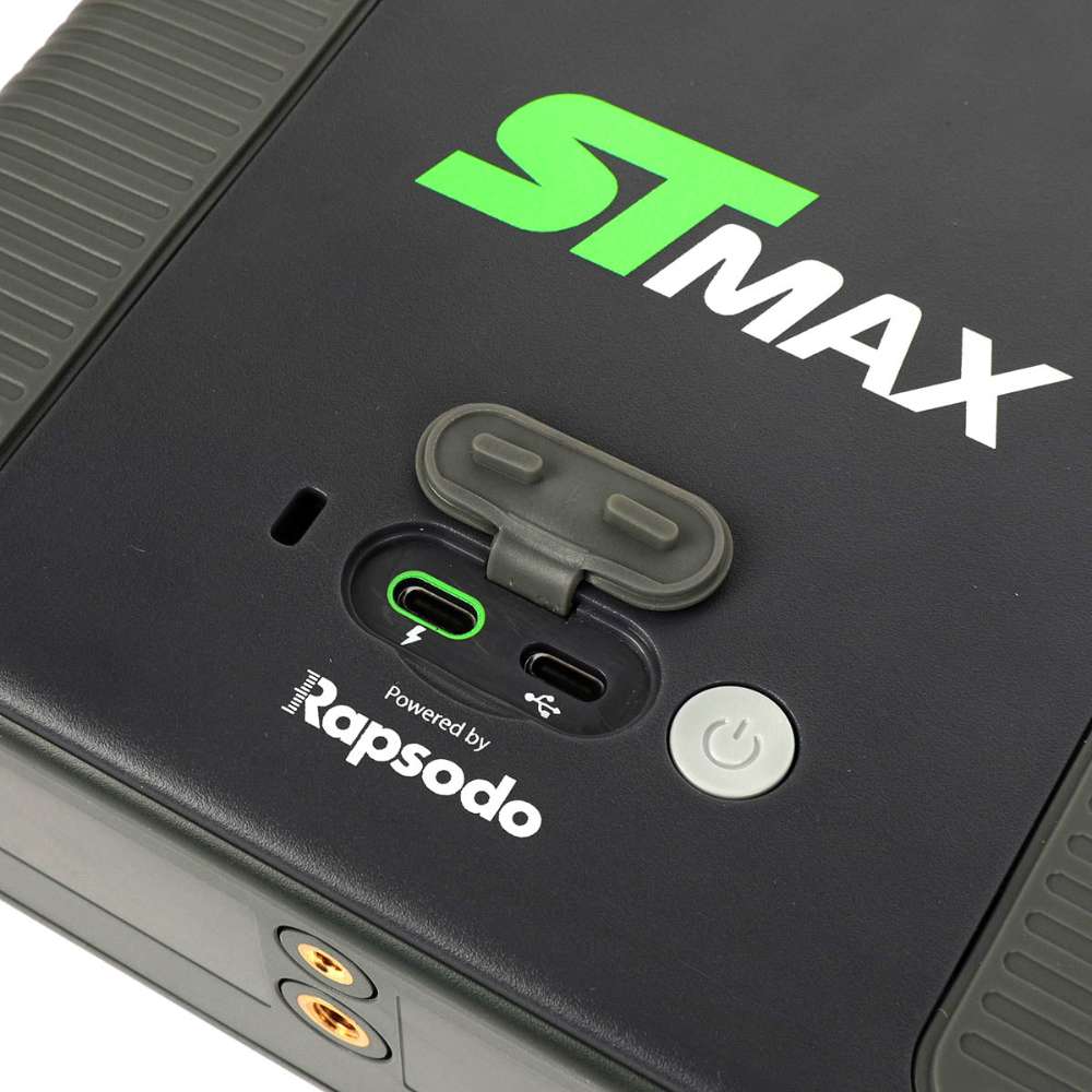 Close-up of SKYTRAK ST MAX Launch Monitor showing two USB ports, a protective cover, power button, and mounting holes