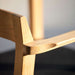 Close-up of Westminster Teak Horizon Teak Dining Armchair focuses on the armrest joint and wood grain detail