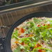 Close-up of a vegetable pizza with arugula, mushrooms, and peppers cooking inside Instant Pot® InstantHeat™ Pizza Oven