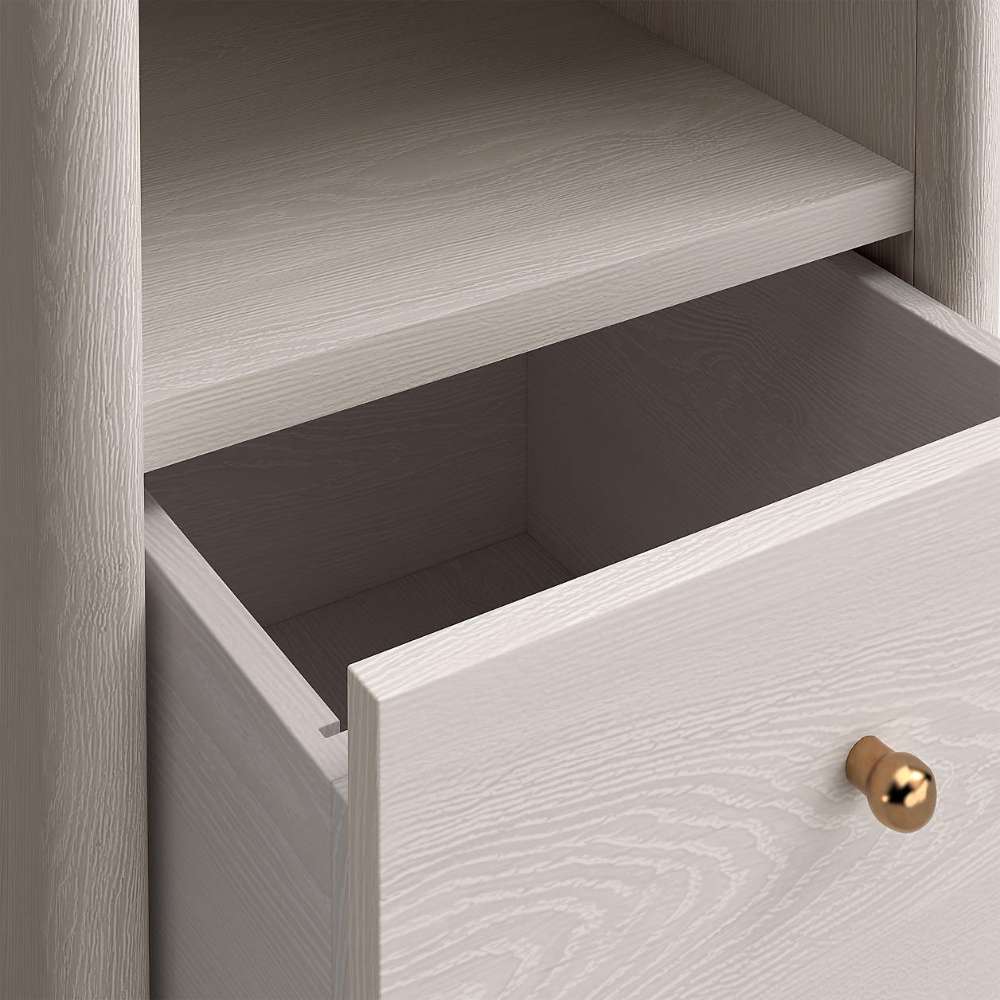 Close-up of an empty open drawer on Crate & Barrel Lafayette 64" Whitewashed Desk with Outlets with a gold knob