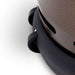 Close-up of black wheels under the curved bronze base of Outdoor Order Halo Traditional Heater