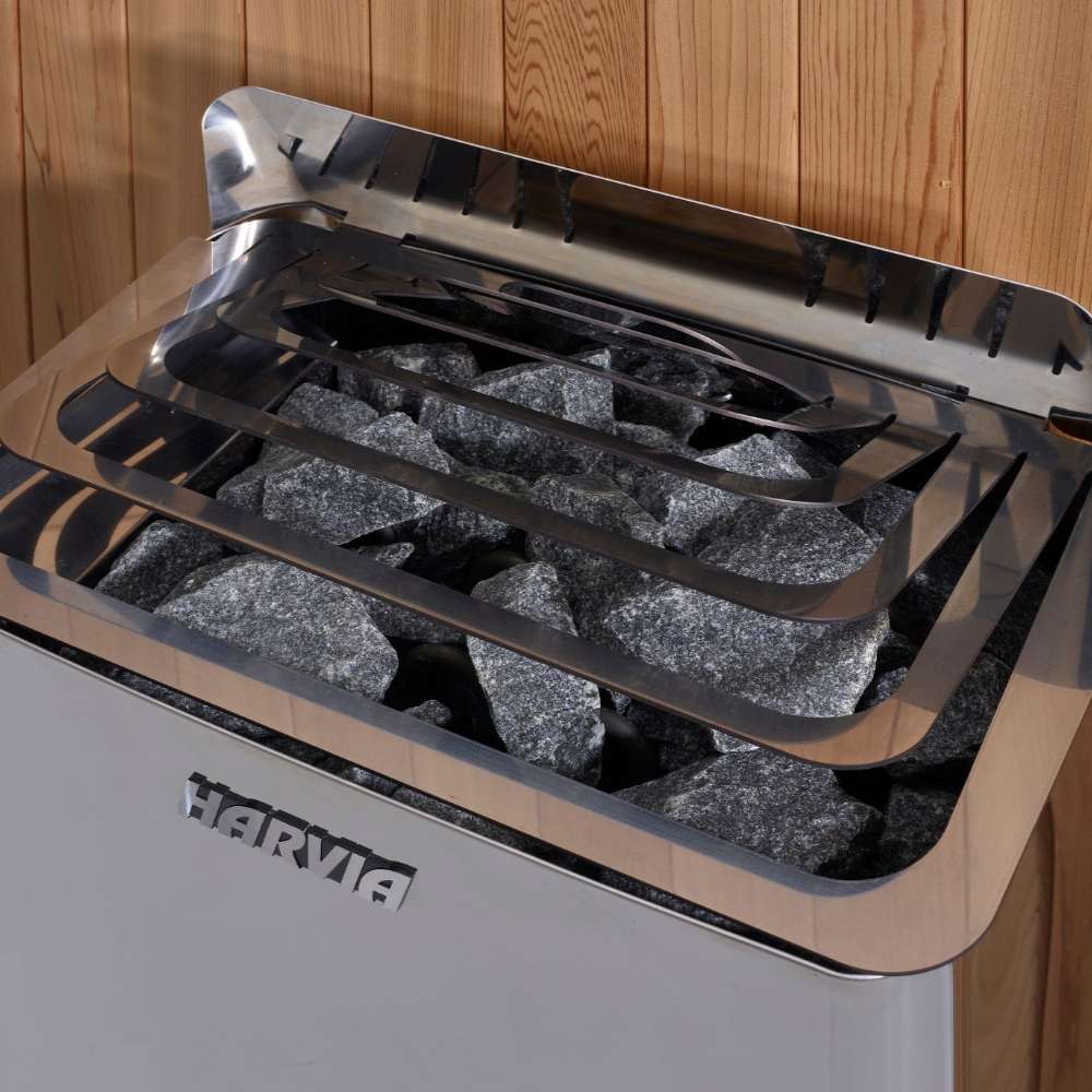 Close-up of gray sauna stones under steel guard rails on top of the Harvia stove in Golden Designs Kuusamo 6 Person Traditional Sauna