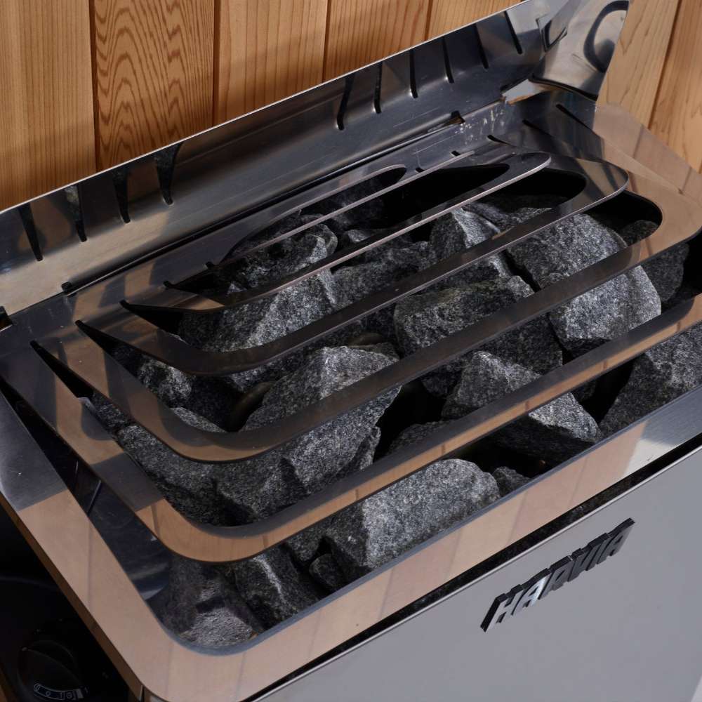 Close-up of gray sauna stones under steel guard rails on top of the Harvia stove in Golden Designs Sundsvall 2 Person Traditional Sauna