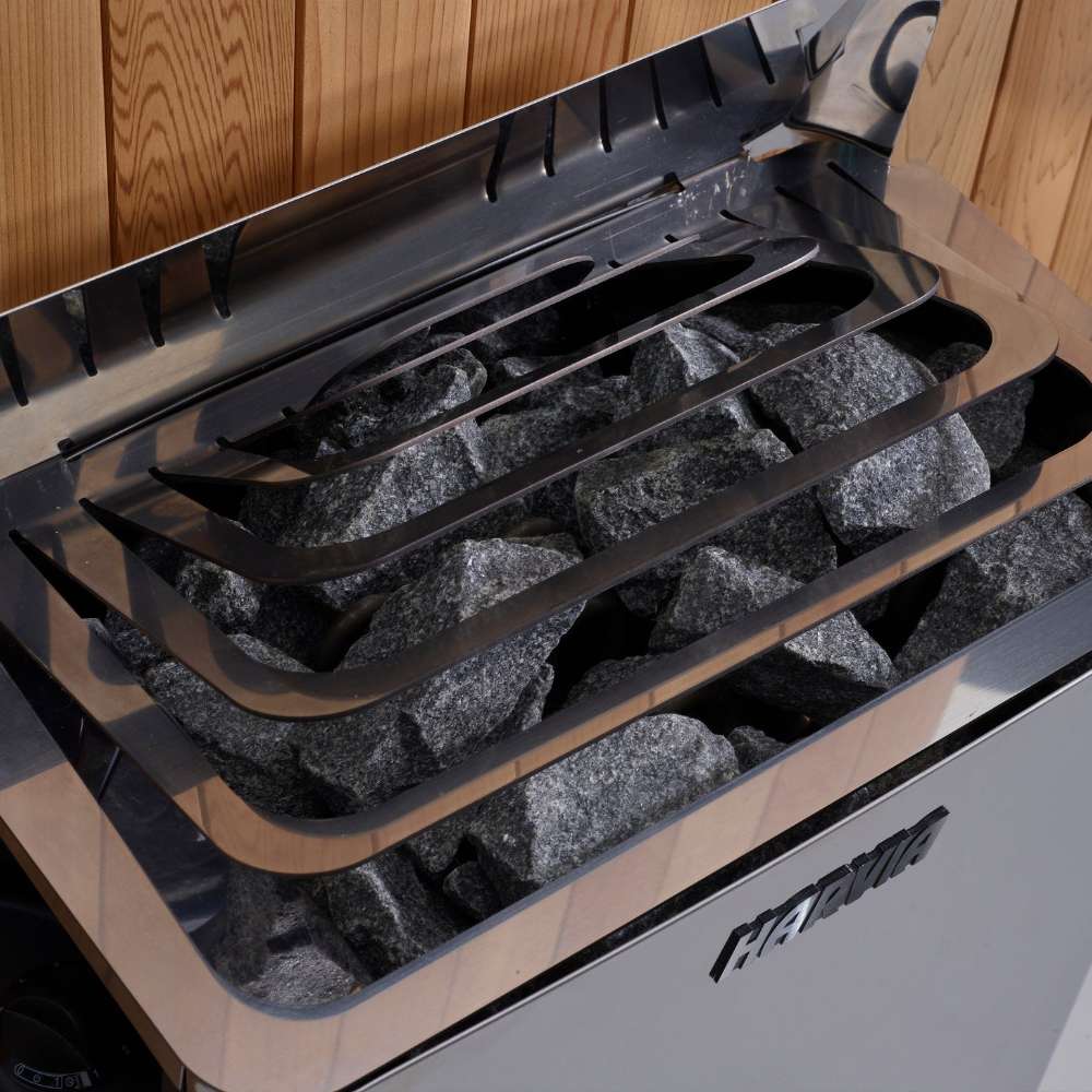 Close-up of gray sauna stones under steel guard rails on top of the stove in Golden Designs Osla 6 Person Traditional Sauna
