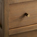 Close-up of the Crate & Barrel Keane 40" Driftwood Storage Bookcase highlighting its driftwood finish and brass knob