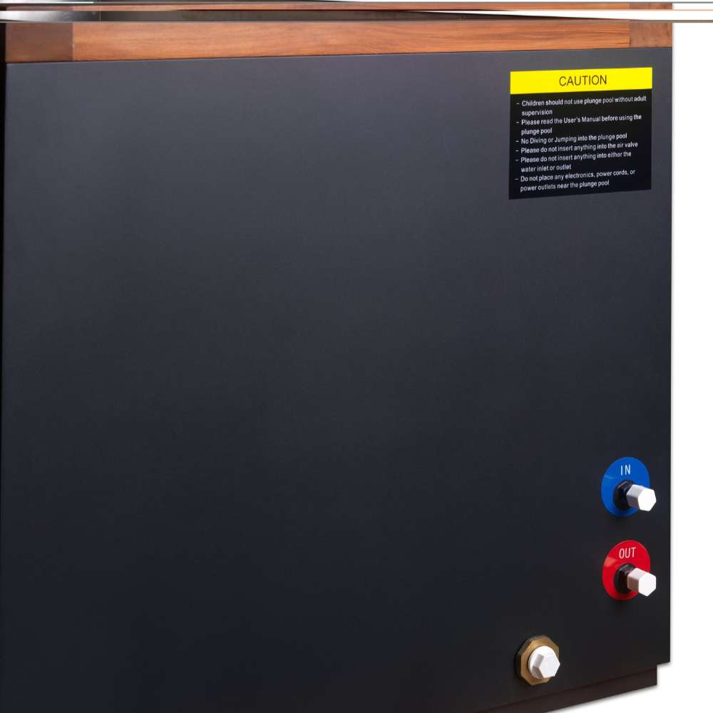 Close-up of the Golden Designs Dynamic Cold Therapy Cuboid 304 Nano-Coated Stainless Steel Cold Plunge Tub XL side panel with blue and red water ports, a brass drain fitting and a yellow caution label
