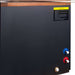 Close-up of the Golden Designs Dynamic Cold Therapy Cuboid 304 Nano-Coated Stainless Steel Cold Plunge Tub XL side panel with blue and red water ports, a brass drain fitting and a yellow caution label
