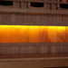 Close-up of the Himalayan salt bar in Golden Designs 2025 Reserve Edition 3 Person Full Spectrum Sauna with Himalayan Salt Bar, a row of glowing amber salt blocks below a bench
