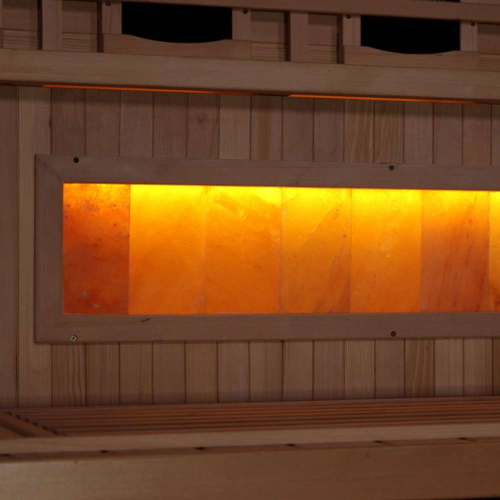 Close-up of the Himalayan salt bar in Golden Designs Reserve Edition 1 Person Full Spectrum Sauna with Himalayan Salt Bar, a row of glowing amber salt blocks below a bench