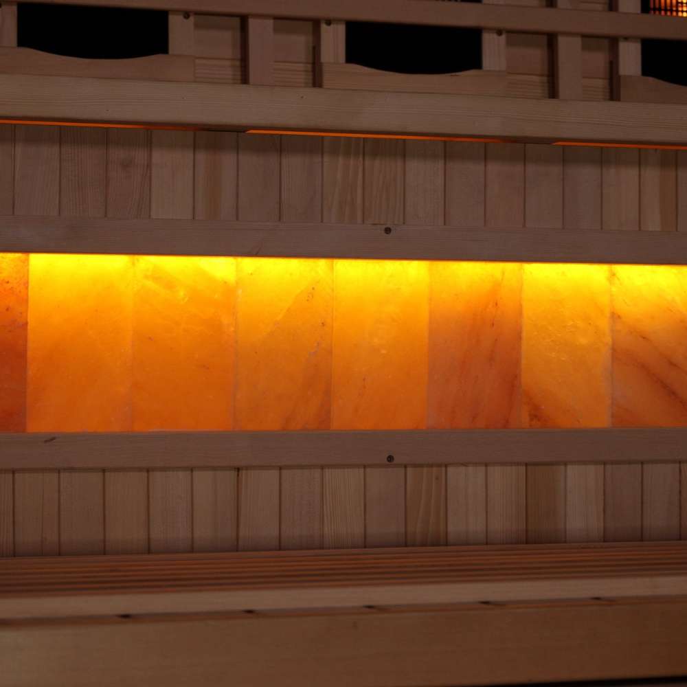 Close-up of the Himalayan salt bar in Golden Designs Reserve Edition 2 Person Full Spectrum Sauna with Himalayan Salt Bar, a row of glowing amber salt blocks below a bench