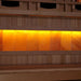 Close-up of the Himalayan salt bar in Golden Designs Reserve Edition 3 Person Full Spectrum Sauna with Himalayan Salt Bar, a row of glowing amber salt blocks below a wood bench