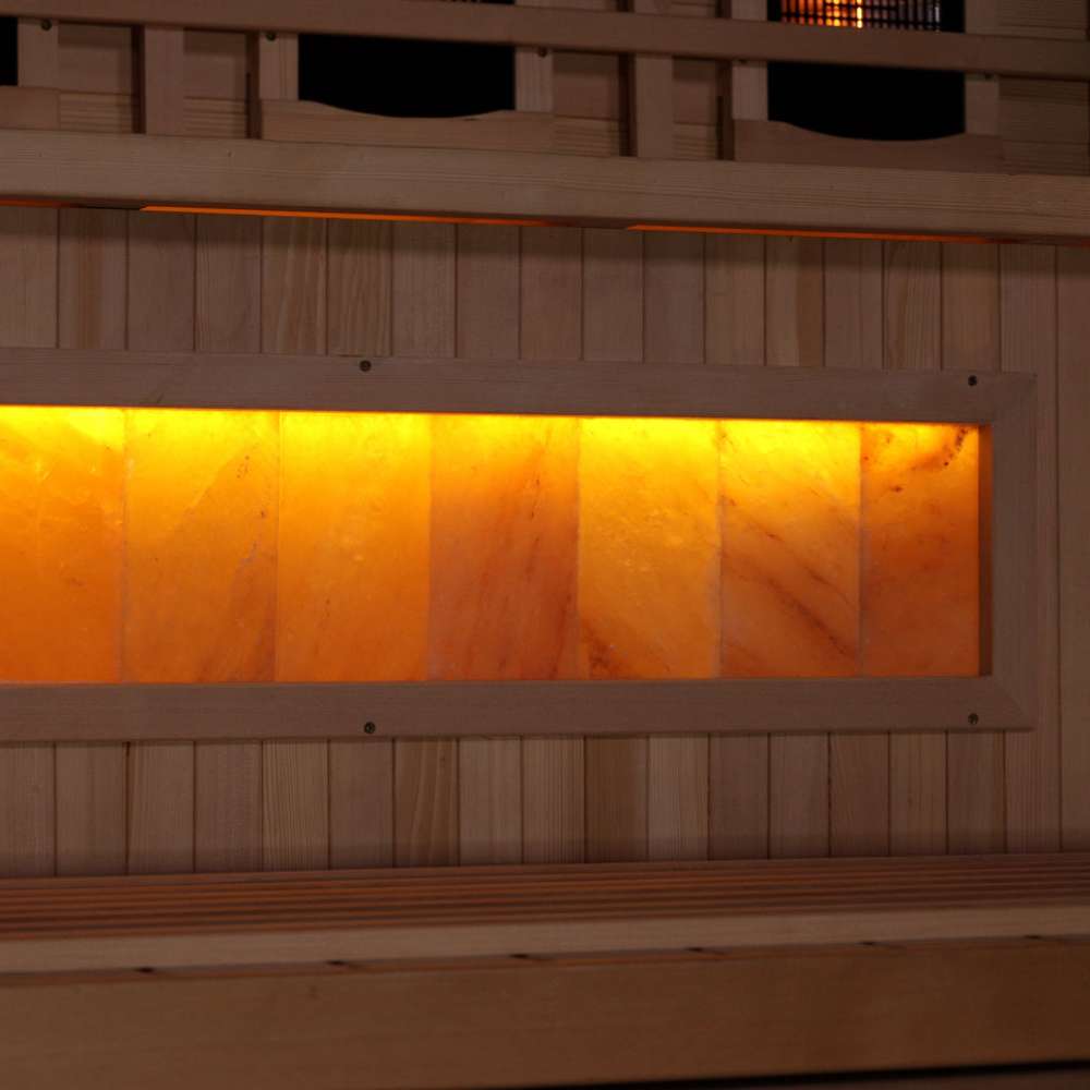 Close-up of the Himalayan salt bar in Golden Designs Reserve Edition 4 Person Full Spectrum Sauna with Himalayan Salt Bar, a row of glowing amber salt blocks below a bench