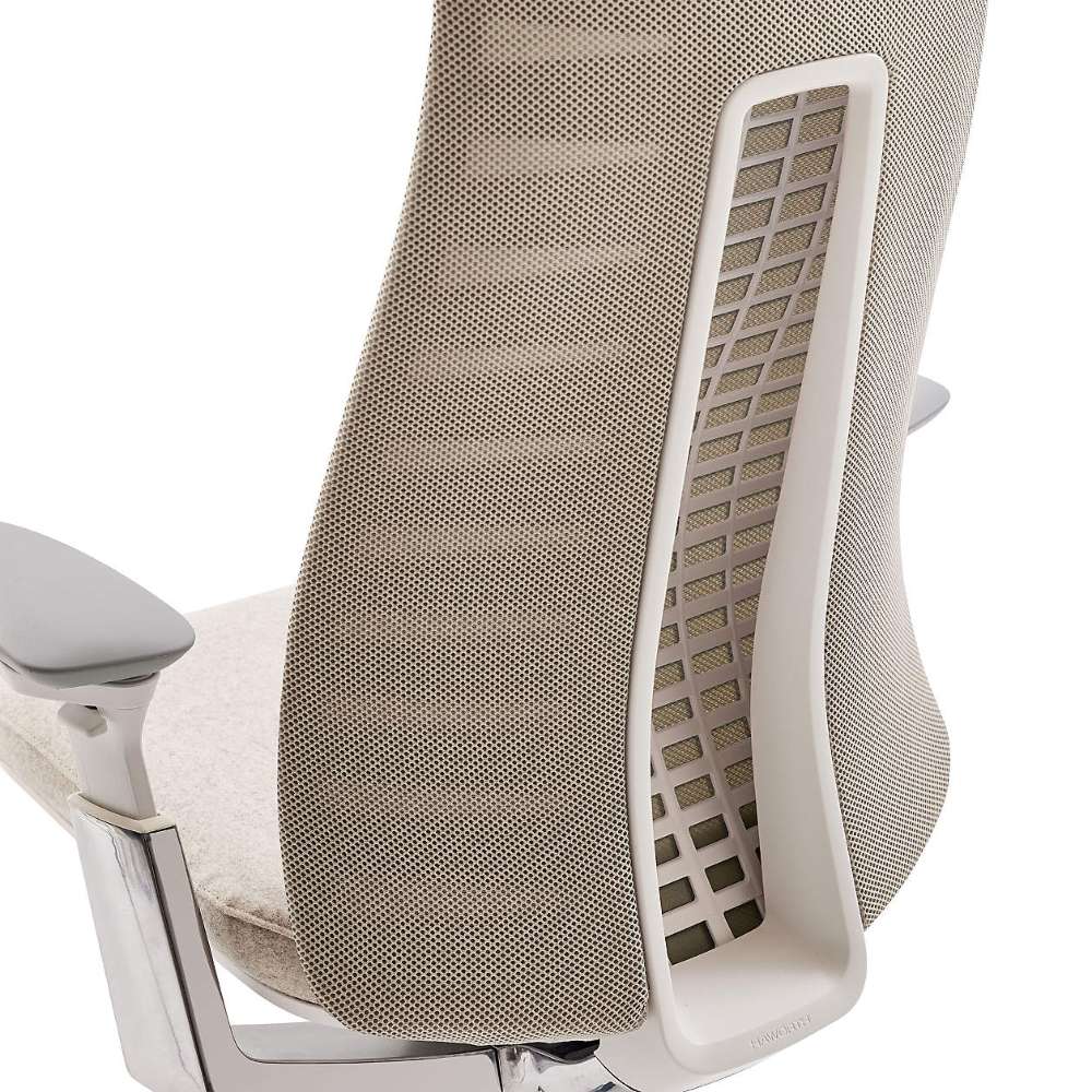 Close-up of the back support on Crate & Barrel Haworth Fern Upholstered Beach Office Chair, showing the flexible spine-inspired support beneath the fabric