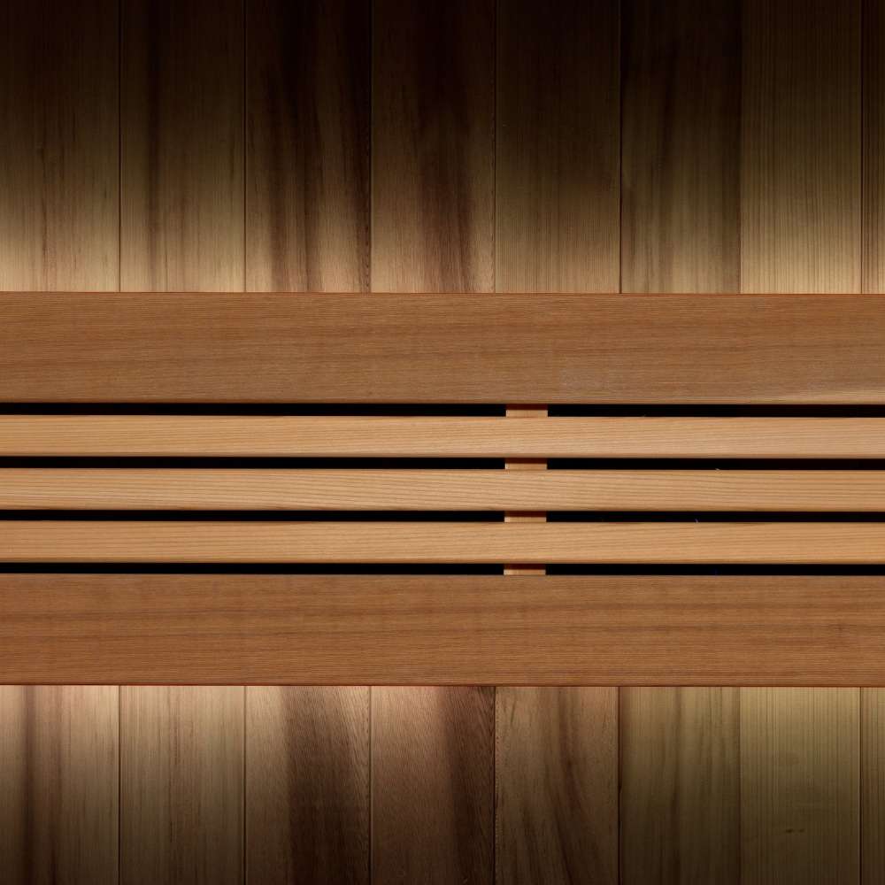 Close-up of the backrest in Golden Designs Copenhagen 3 Person Traditional Sauna, where warm accent light glows behind horizontal cedar slats