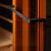 Close-up of the black finish towel bar handle against the glass and warm wood of Golden Designs Reserve Edition 3 Person Full Spectrum Sauna with Himalayan Salt Bar