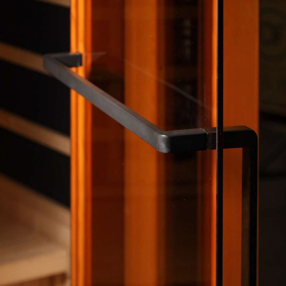 Close-up of the black finish towel bar handle against the glass and warm wood of Golden Designs Reserve Edition 4 Person Full Spectrum Sauna with Himalayan Salt Bar